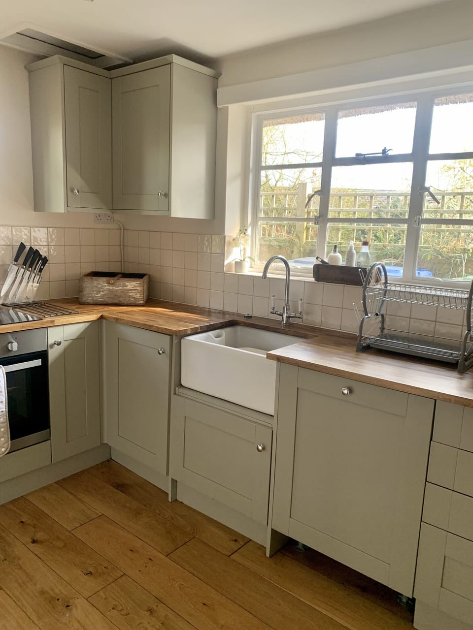 Modern kitchen with dishwasher, oven, hob & microwave. Tall fridge in pantry. 