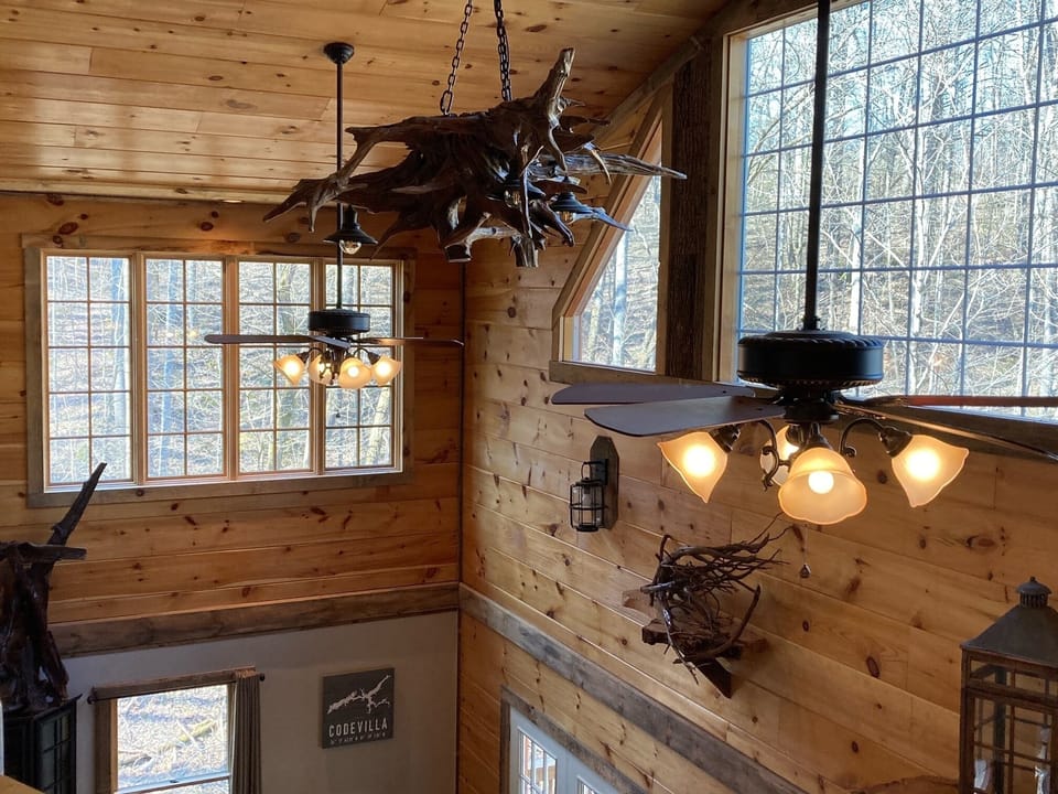 Interior view from loft. Custom chandelier made from salvaged lake driftwood.