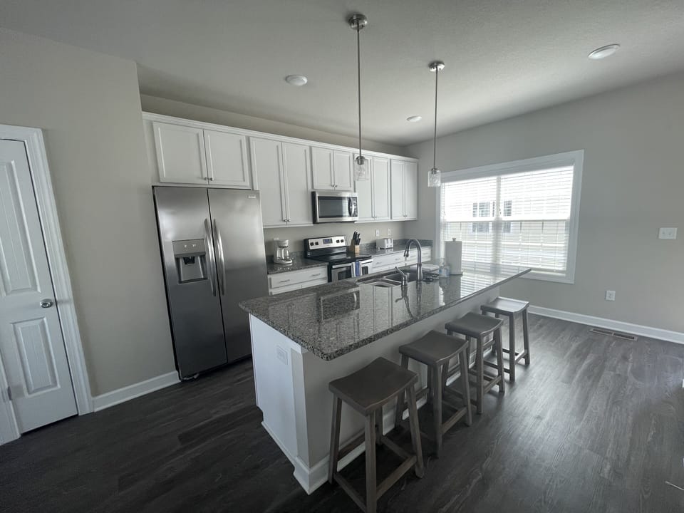 Open kitchen with updated appliances and bar