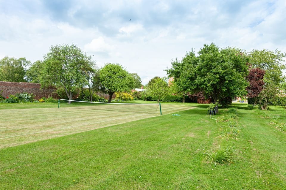 Shared, seasonal, grass tennis court