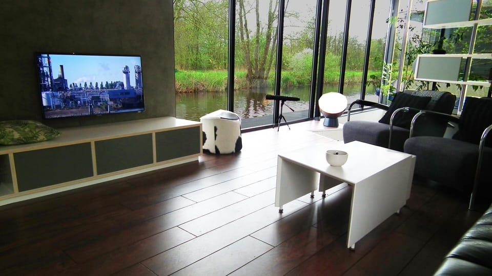 Holiday Water Villa Intermezzo Near To Giethoorn And Is To rent. Docked boat in Giethoorn