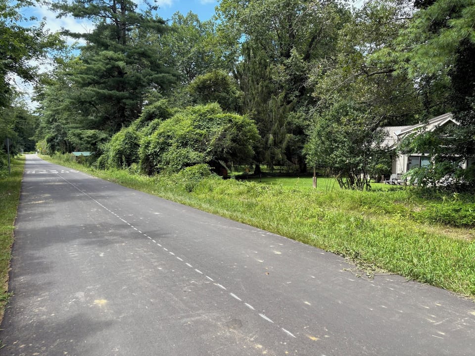 The Ecusta Trail with house on the right (borders the trail)