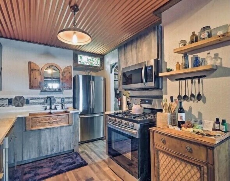 Refrigerator, ice maker, microwave, dishwasher, dishes, flatware, cookware 