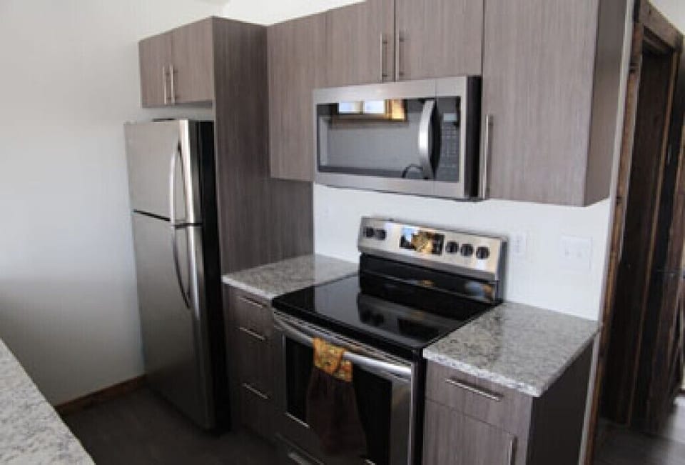 Beautiful  kitchen with full-size fridge, microwave, oven, dishwasher.