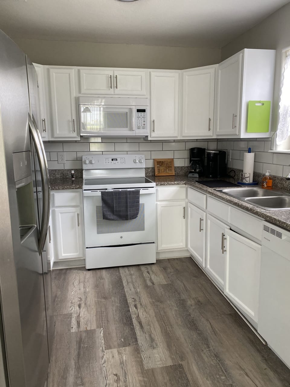 Fully stocked kitchen with new glass top stove, microwave, dishwasher, ss fridge