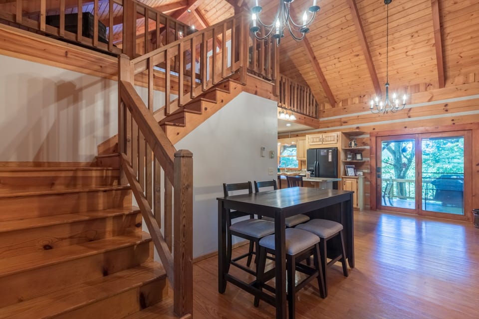 Breakfast nook next to the  coffee bar and fireplace. Stairs leading to the loft