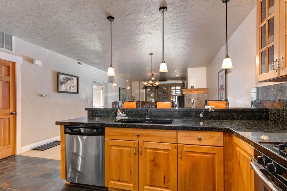 Fully Equipped Kitchen with gorgeous stone countertops, stainless steel LG appliances, built-in ice maker and bar seating for three