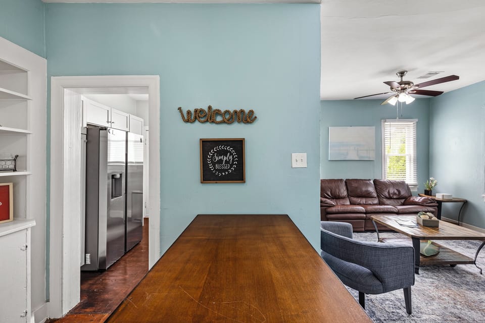 The kitchen opens to the dining area — gather around the table for a shared meal, or step out to the porch with your coffee and take in the morning air.