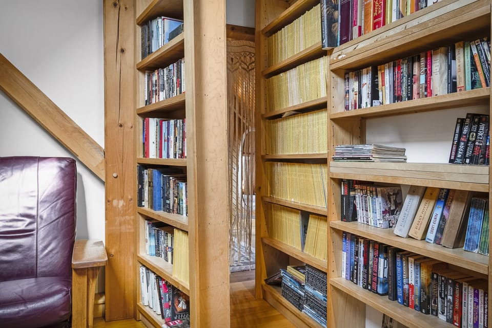 This detail is sure to delight: a secret passage behind the bookshelf!