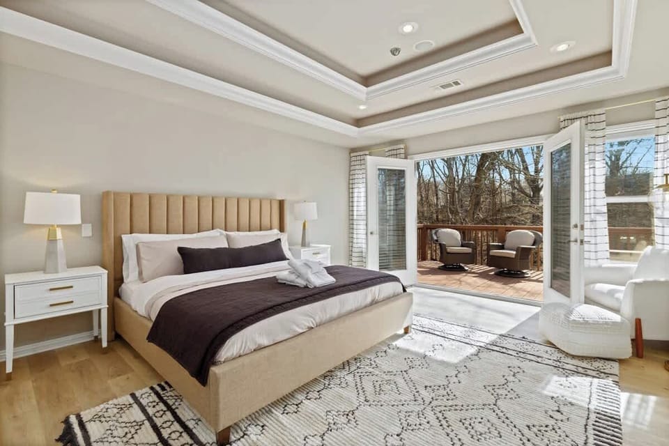 The first of our maximum luxury master suites at this home features a plush King-size bed, seating, a private balcony, and an en suite master bathroom that features a jacuzzi tub.