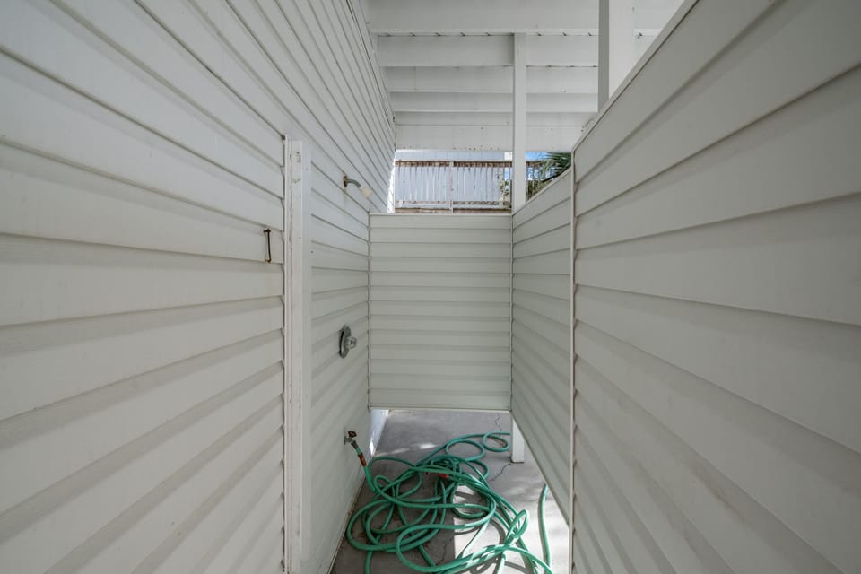 Rinse away the sand in the out door shower.