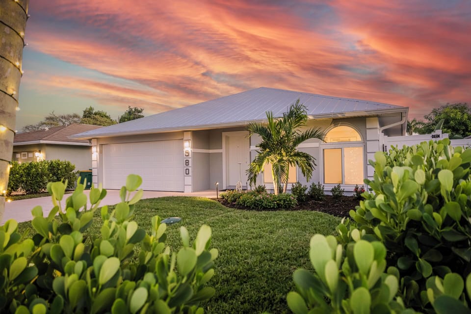 Front of the Coastal Beach House located in Naples Park, early evening.