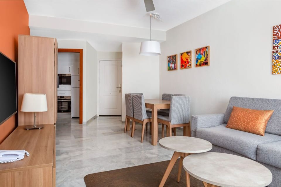 Open-concept living space with vibrant pops of color, providing a modern and inviting atmosphere.