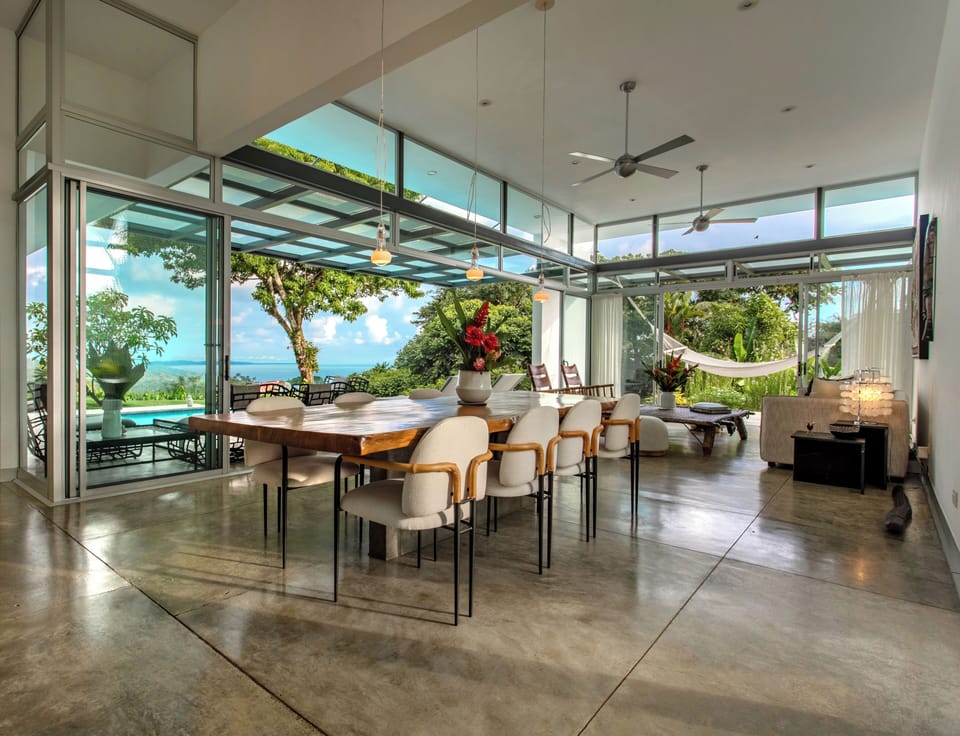 Ocean and jungle view great room that flows seamlessly out to the poolside patio