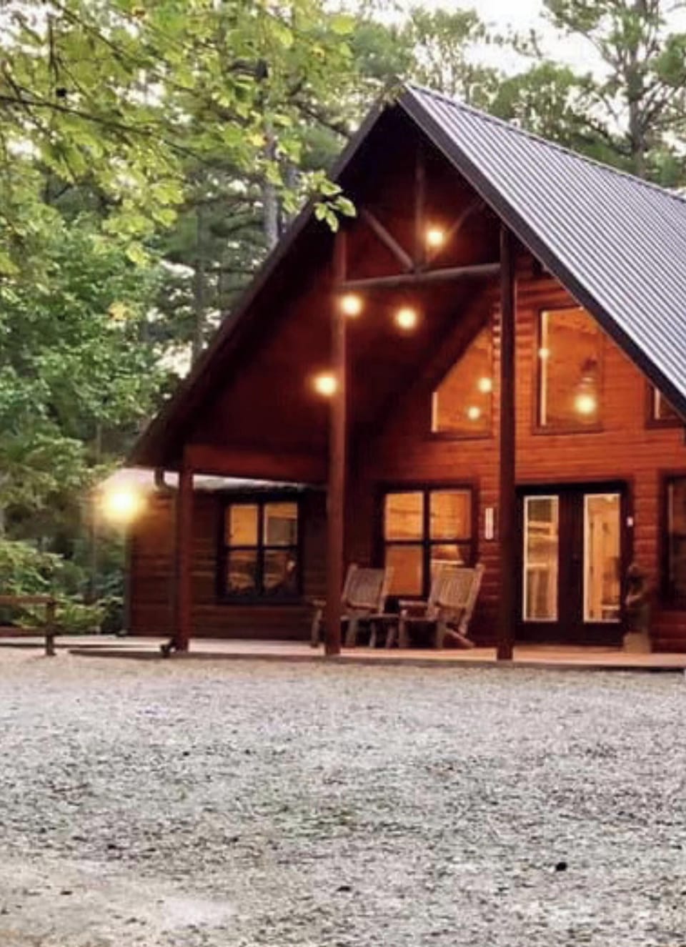 A secluded cabin retreat nestled among towering trees, featuring a hot tub, bunk room, and private boat parking for your lakeside escape.