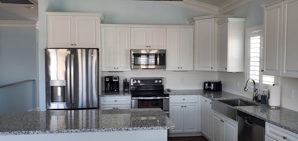 Kitchen has fridge, double oven, microwave & dishwasher. 
