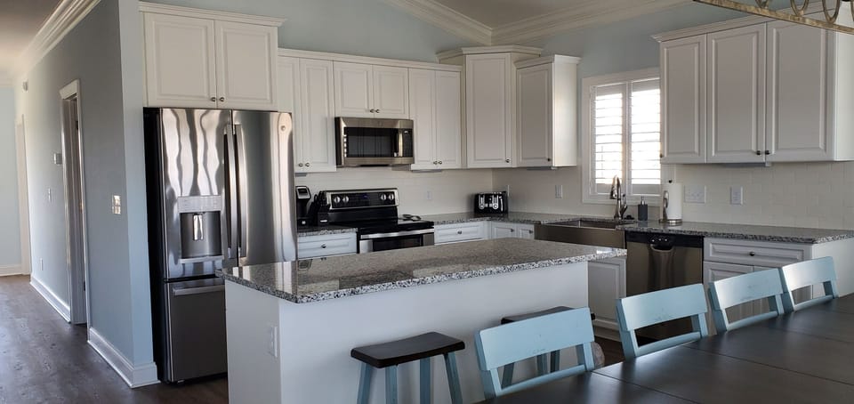 Kitchen area with large island that seats 4.