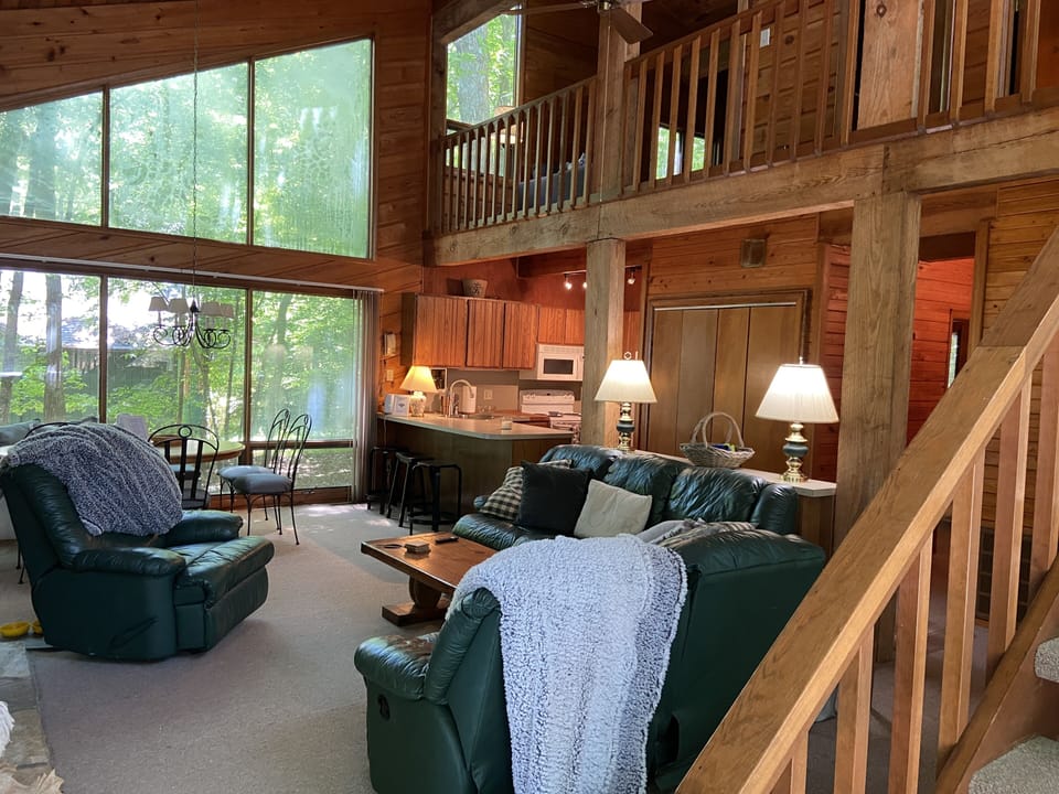 The living room exudes a cozy ambiance with its rustic log cabin-inspired decor.
