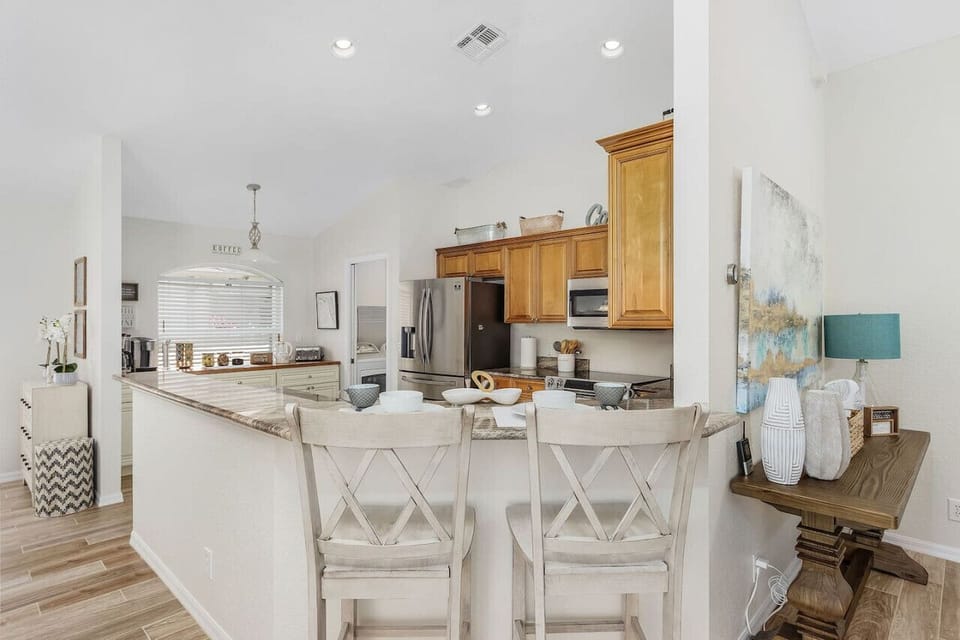 The open concept living area flows from the living area through to the dining area, a breakfast bar and the fully equipped kitchen with coffee bar!