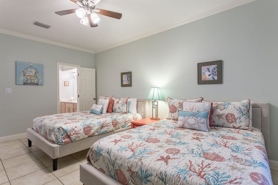 Comfortable guest room with two Queen beds and a flat-screen TV.