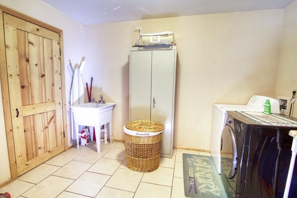 Laundry room including ironing board and iron