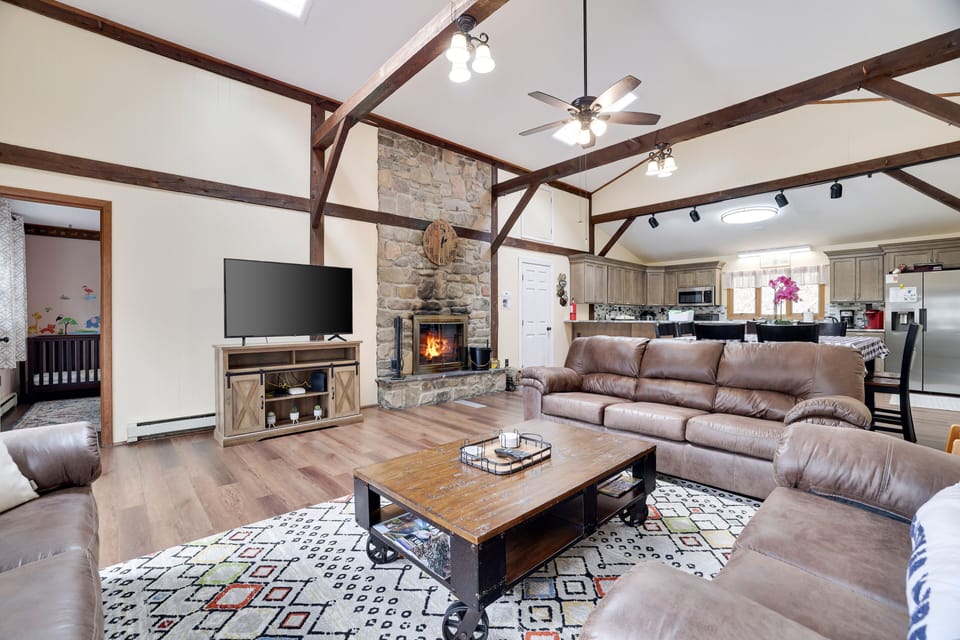 Huge, open concept living room with wood burning fire place and cable TV 