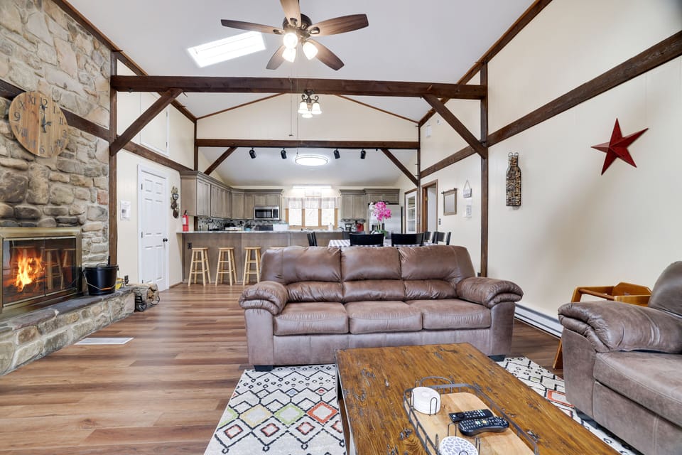 Huge, open concept living room with wood burning fire place and cable TV 