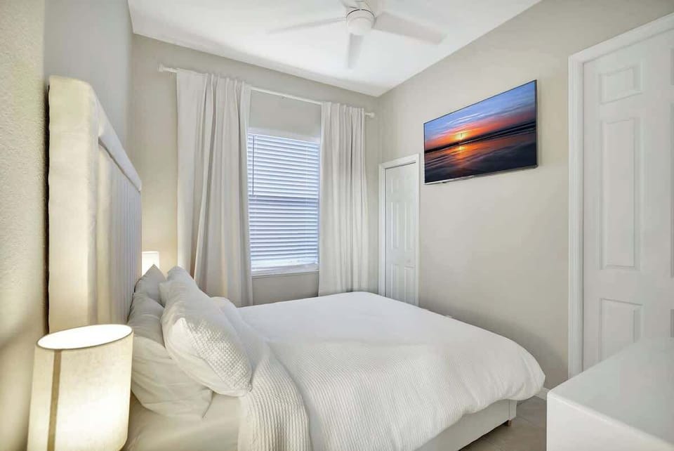 Bedroom #4 offers a cozy queen-sized bed & a Smart TV for effortless streaming with walk-in bathroom!