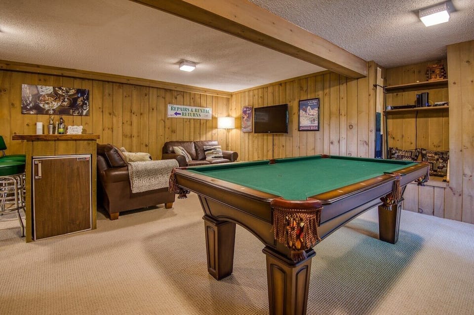The lower level features FUN for everyone.  Complete with a pool table, bar, TV, and arcade games, this is always one of the favorite spaces!