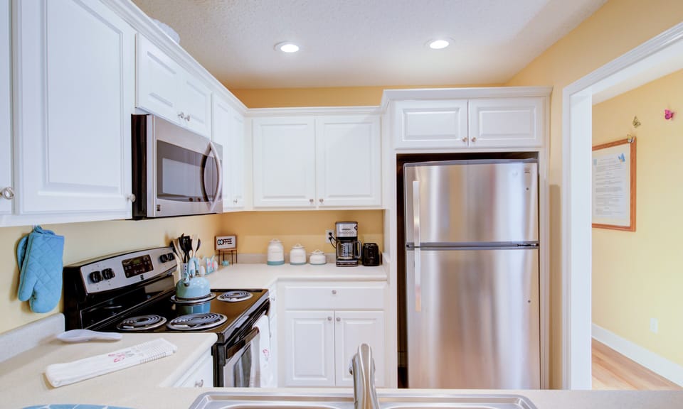 fully stocked kitchen with stainless steel appliances!Complementary water bottle