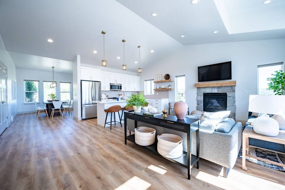 The open-concept living space, complete with a dining area, facilitates effortless conversation with family and friends.