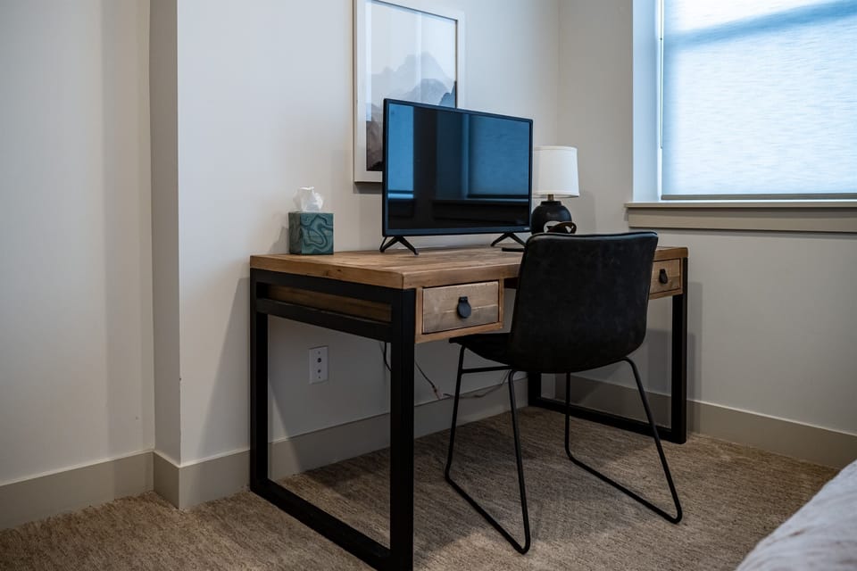 There is a work area, complete with desk, chair and monitor, located in the second bedroom.