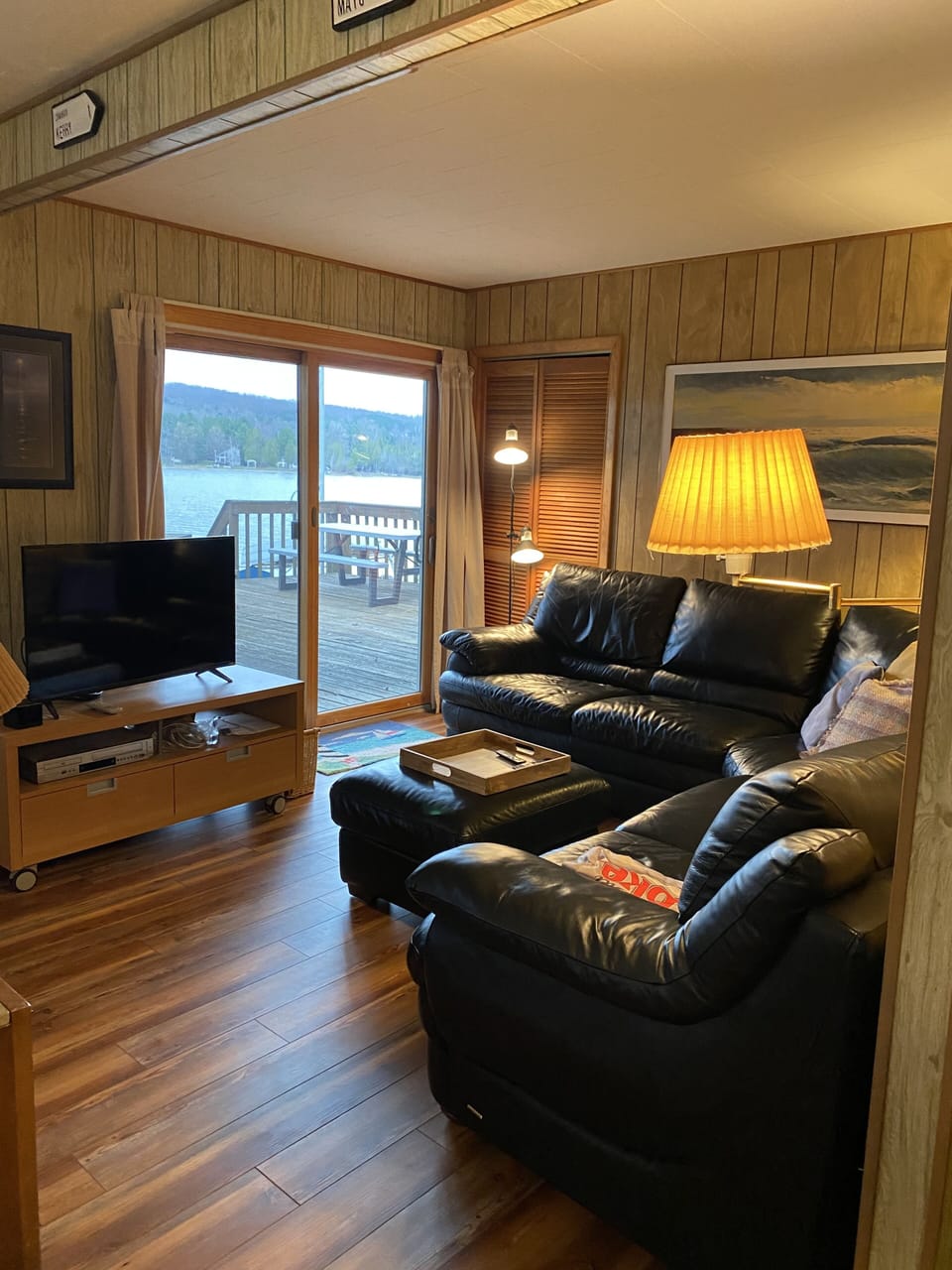 View of tv area in cottage by lake