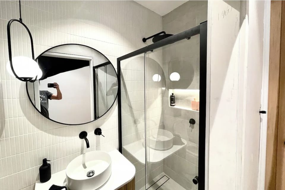 The upstairs powder room with kit kat tile and feature lighting.