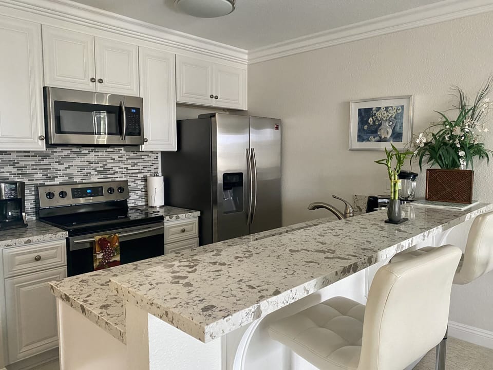 Kitchen view and bar, complete with new Samsung appliances.