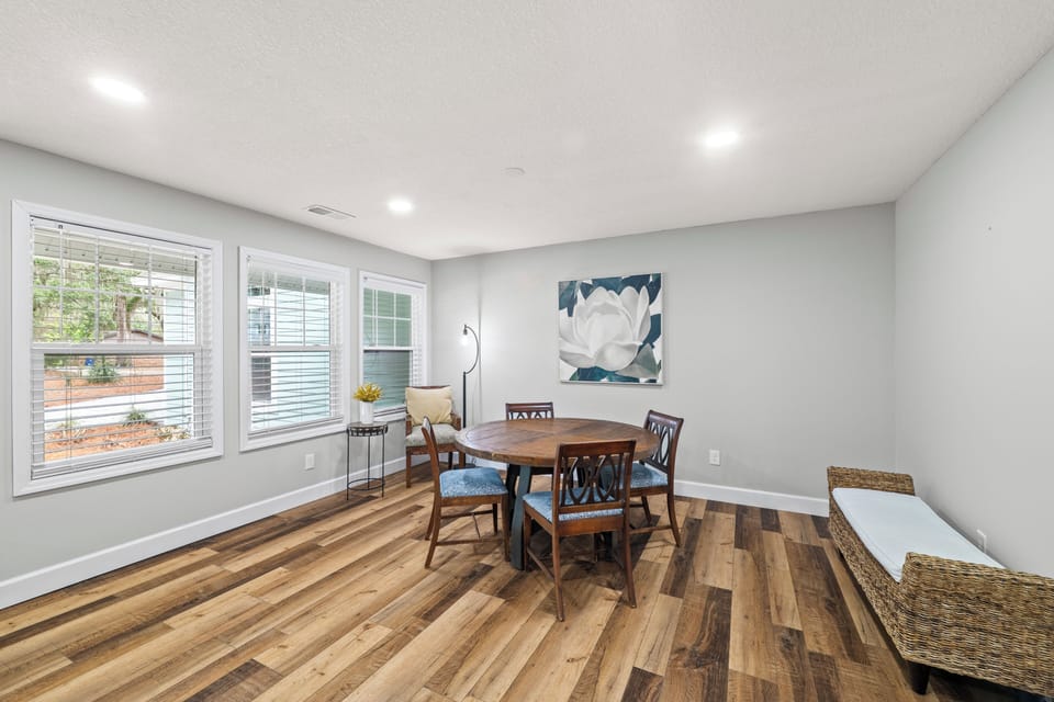 Sunny Living Area with Flat Screen TV, Gas Log Fireplace, and Breakfast Table with Seating for Four