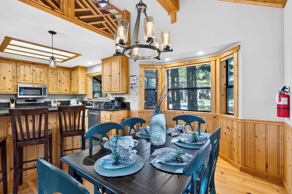 Wood-accented dining room with forest views and a warm cabin-inspired feel.