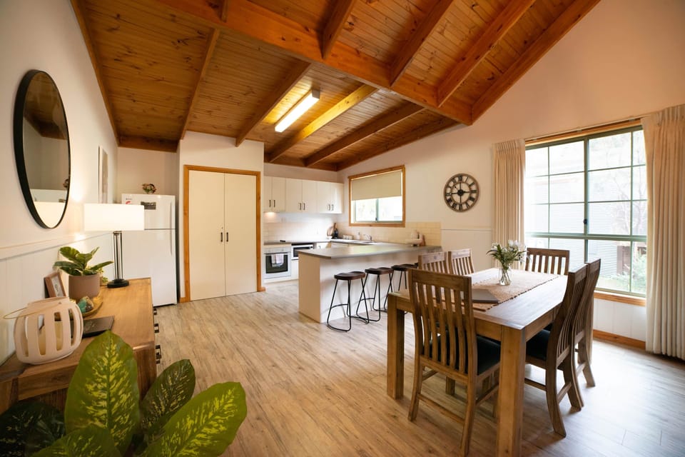 Charming dining and kitchen area with breakfast bar for delightful meals together.