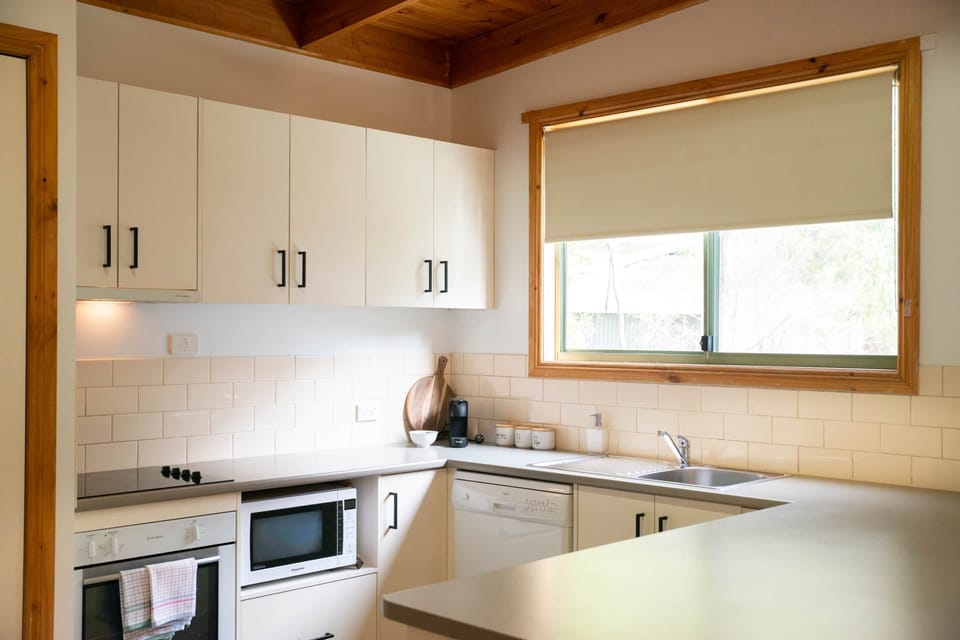 Practical Kitchen with Dishwasher, Oven, Microwave and plenty of room.