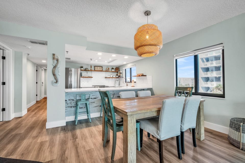 Seat 6 at the dining room table with 4 bonus barstool at the kitchen counter