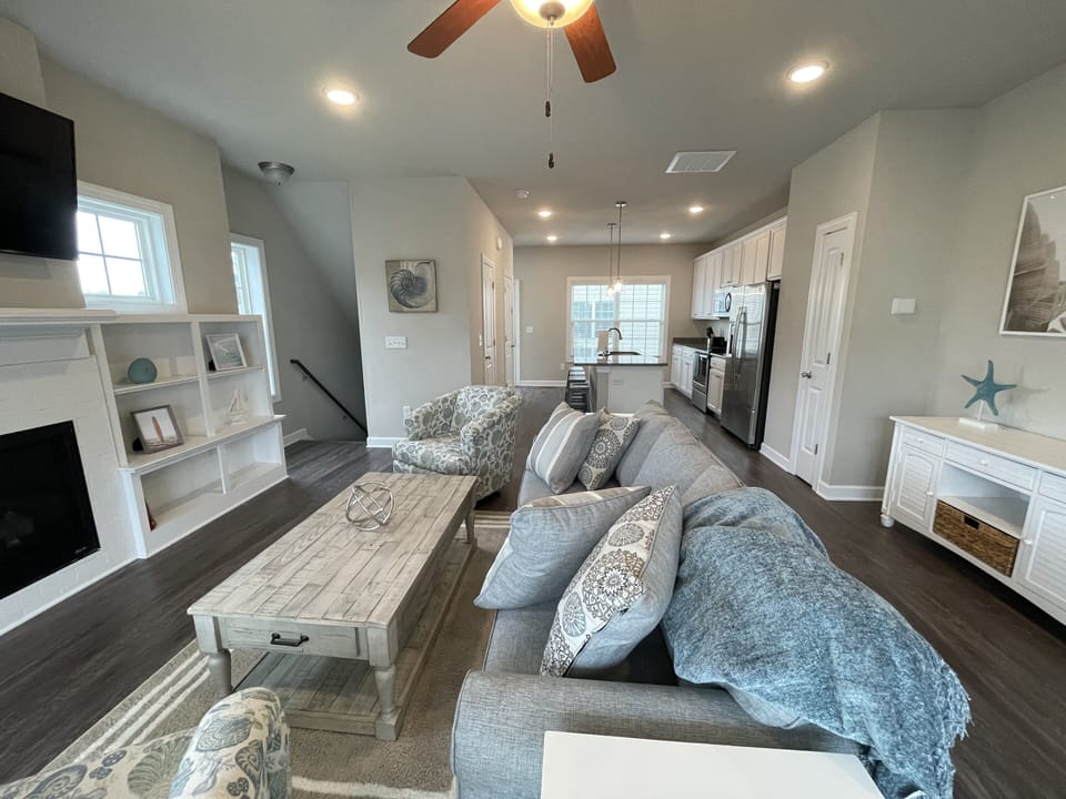 Open concept living area with living room, dining area, and kitchen 