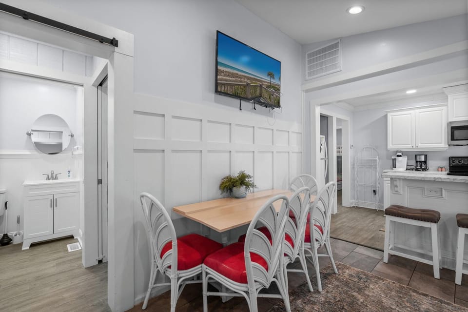 Cozy dining nook with bright, modern kitchen access