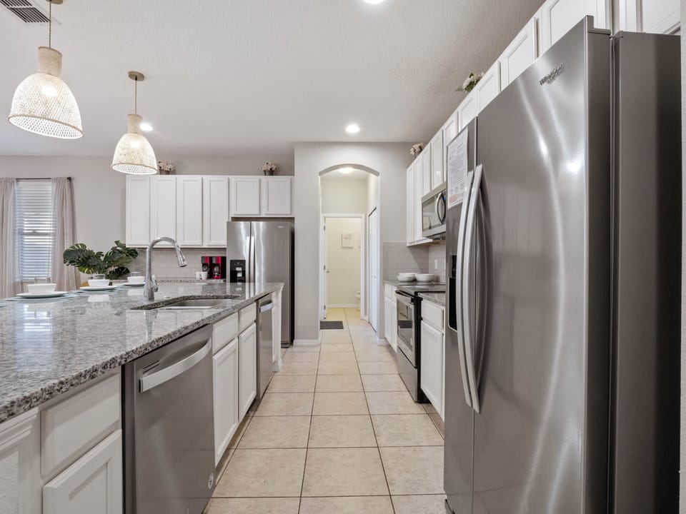 - Cook with ease in a fully equipped kitchen with stainless steel appliances  
- Spacious granite countertops and modern cabinetry make meal prep simple  
- Open layout connects directly to dining and living spaces seamlessly