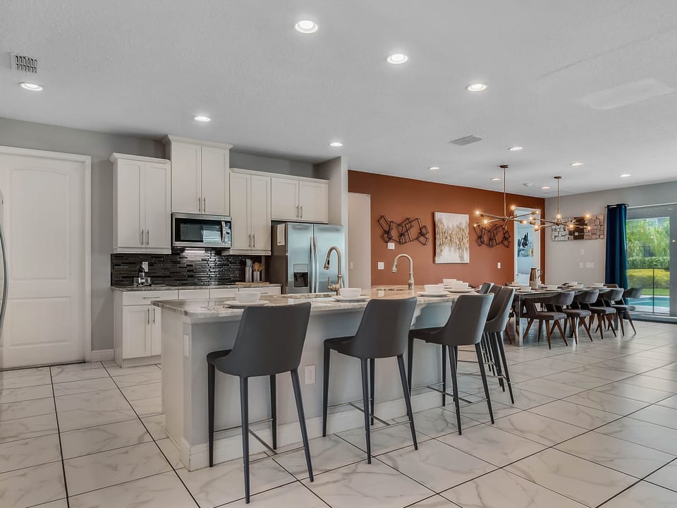 - Open kitchen with breakfast bar and sleek design  
- Modern appliances and ample counter space for meals  
- Connected dining and living area for family comfort