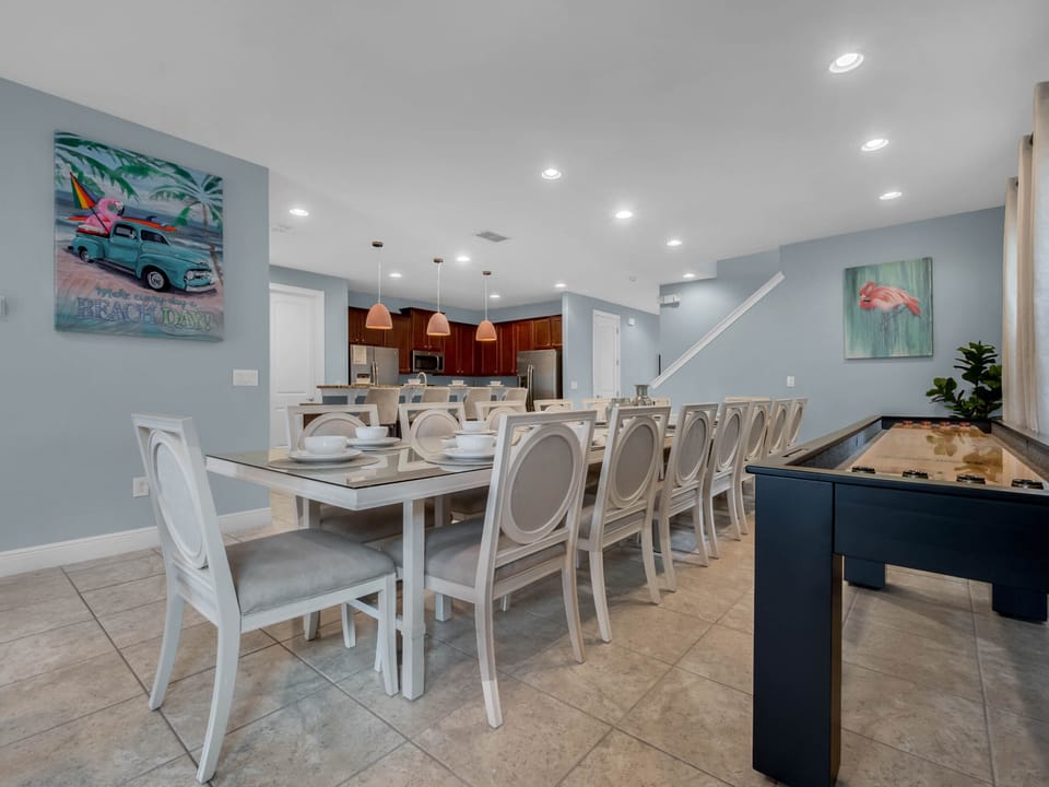 - Large dining table with seating for big groups perfect for vacation stays  
- Bright wall art and shuffleboard bring fun energy to family meals  
- Ideal for group-friendly rentals near Orlando attractions