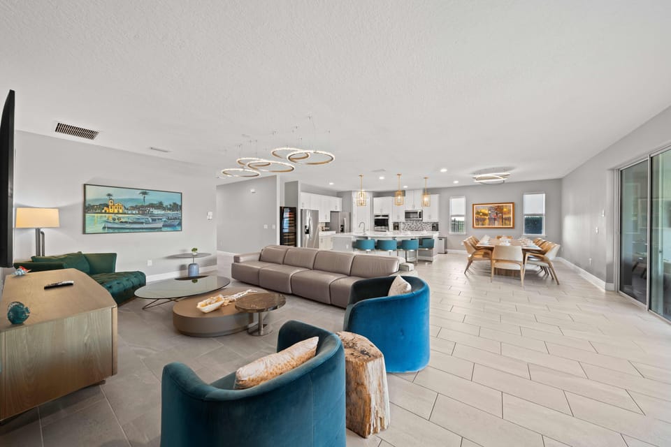- Bright modern living room with open plan and comfort  
- Large sectional sofa and stylish decor for gatherings  
- Vacation rental near Disney with contemporary design