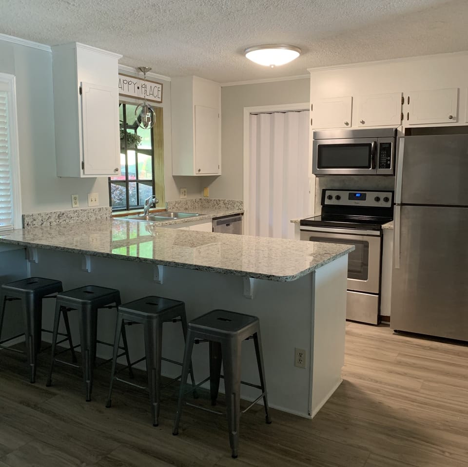 Kitchen and bar area with seating for 4