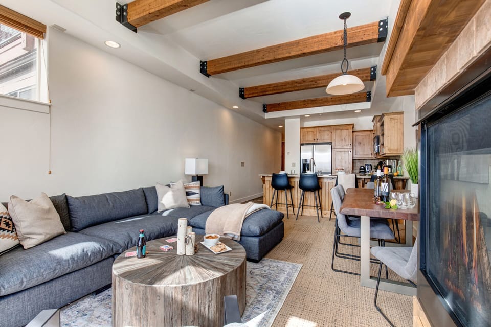 Living Room with 55" Samsung smart tv, gas fireplace, plush sectional sofa, ample natural light and private hot tub patio access