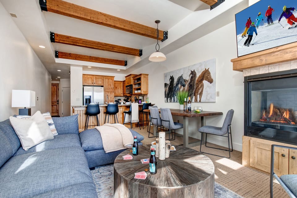 Living Room with 55" Samsung smart tv, gas fireplace, plush sectional sofa, ample natural light and private hot tub patio access