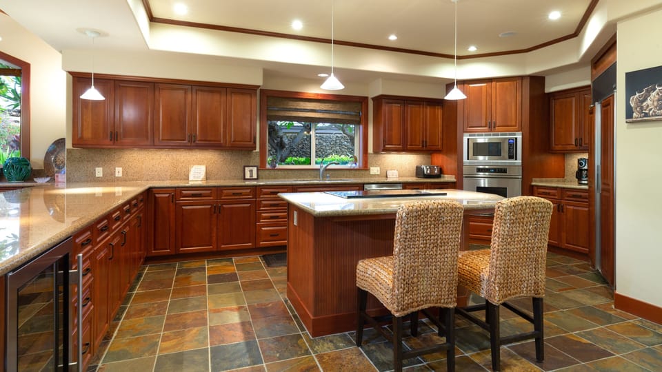 Spacious kitchen stocked with spices, oils and cooking essentials